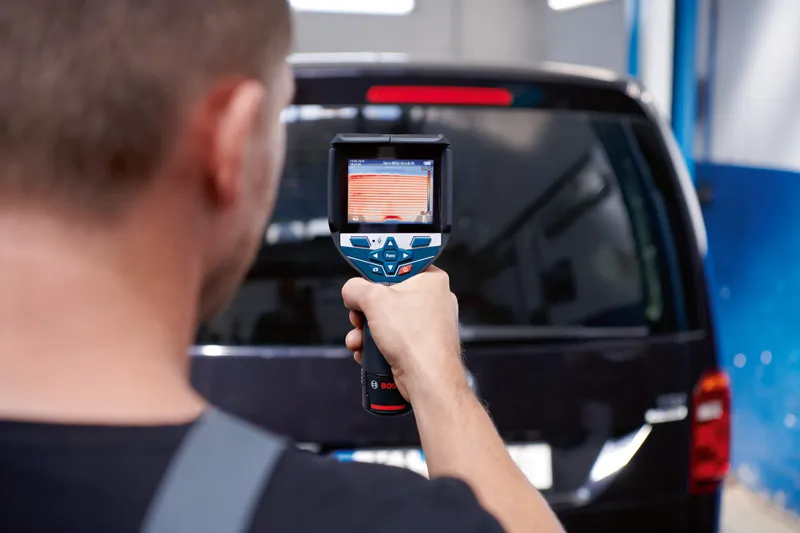 ผู้ใช้กล้องเทอร์โมสแกนกระจกหลังรถยนต์.