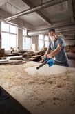 เครื่องเป่าลม Bosch GBL 650 กำลังช่วยขจัดขี้เลื่อยจากโต๊ะทำงาน