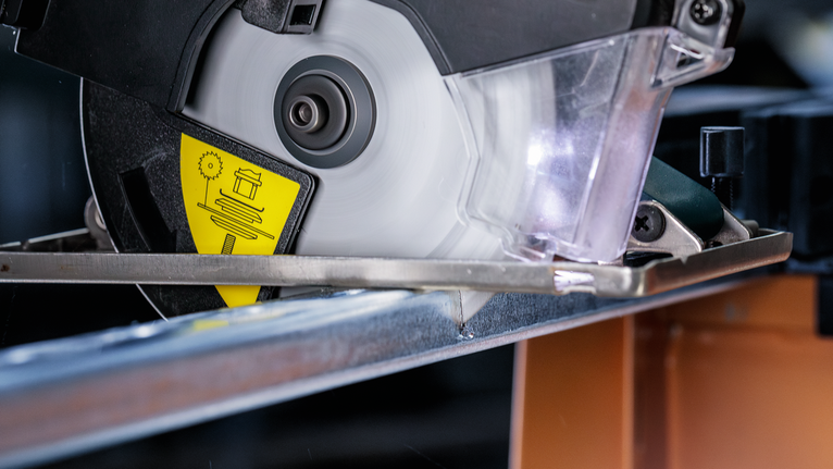 ใบเลื่อยวงเดือนตัดผ่านคานโลหะในโรงงาน