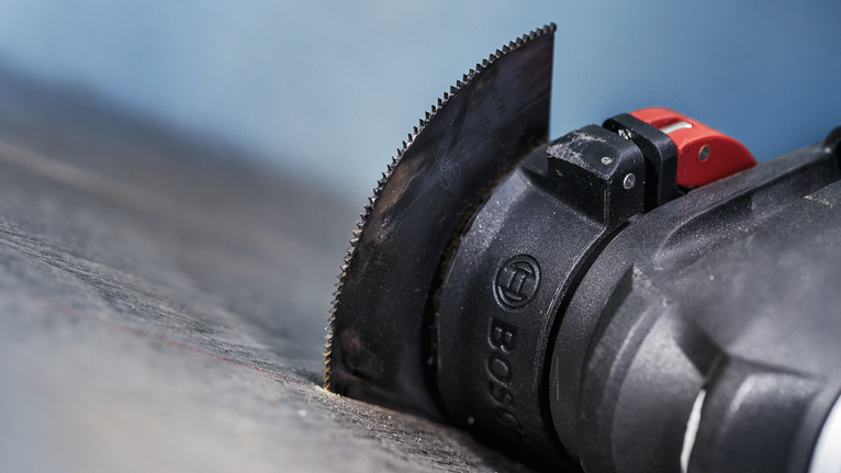 เครื่องมืออเนกประสงค์แบบสั่นพร้อมใบมีดตรงที่สามารถตัดบนพื้นผิวสีเข้ม