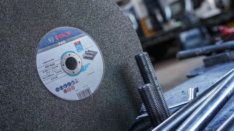 ใบตัดขัดขนาดใหญ่วางอยู่ข้างๆ แกนโลหะที่มีเกลียวในโรงงาน